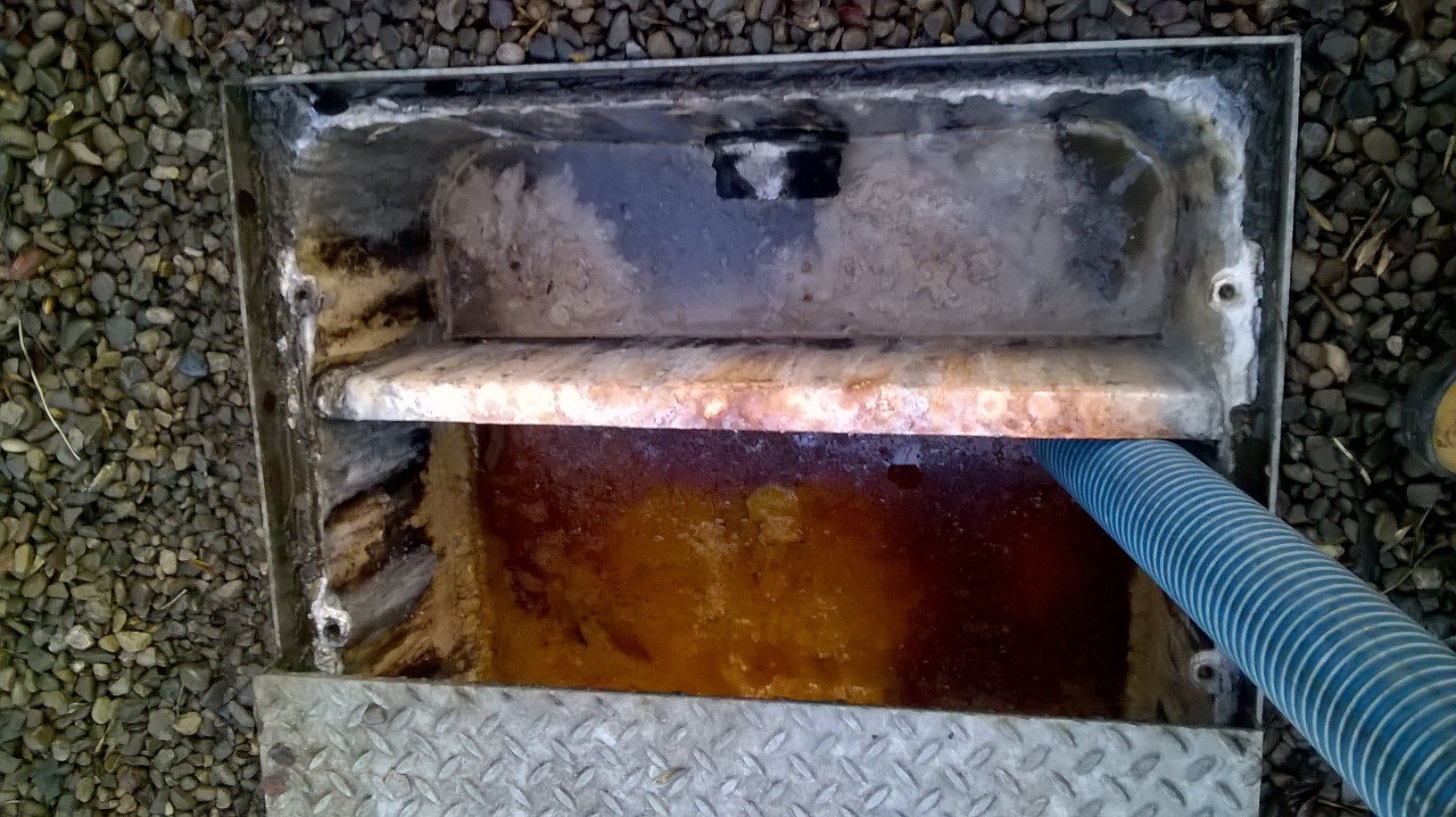 Eco Clarity grease trap outside grease trap being pumped out